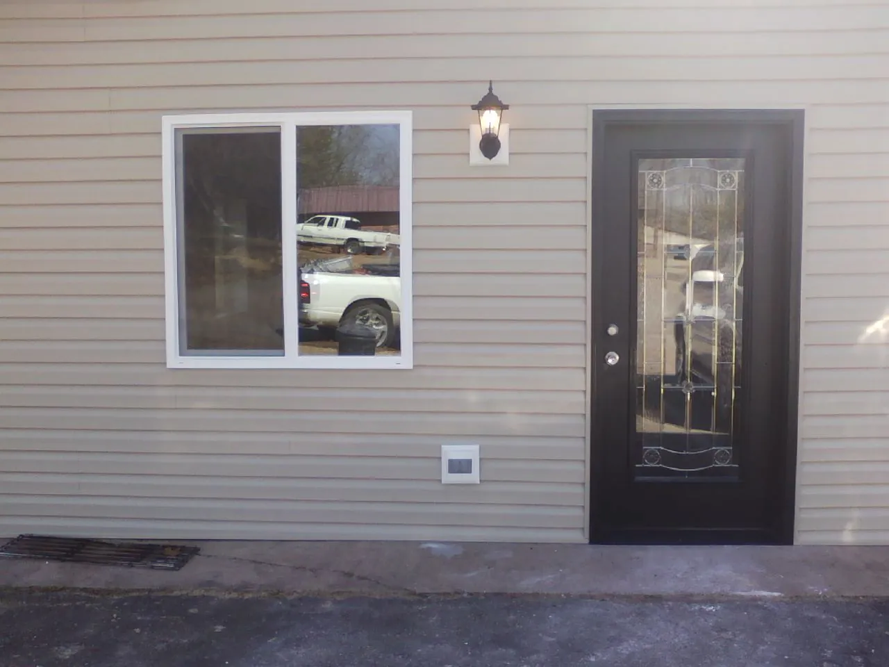 New siding, window and entry door on the side of an addition in Montezuma